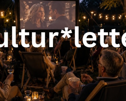 Menschen sitzen in Liegestühlen im Open-Air-Kino.